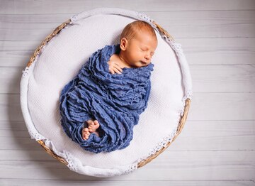 newborn baby enveloped blue scarf sleeps white pillow 8353 848