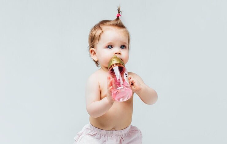 portrait beautiful baby girl toddler stay diaper with pink bottle water 496169 798